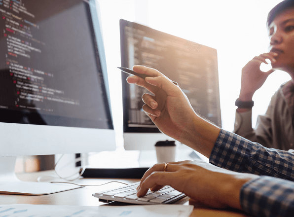 Hand pointing to code on a screen