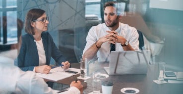 A data analyst advising his colleagues at an executive board meeting