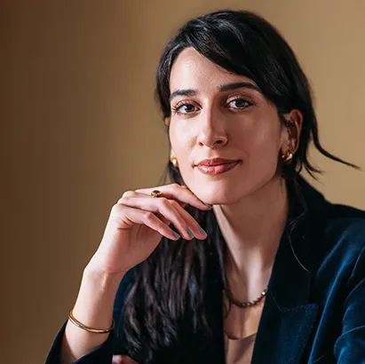 Portrait of a woman in a striking black business suit.