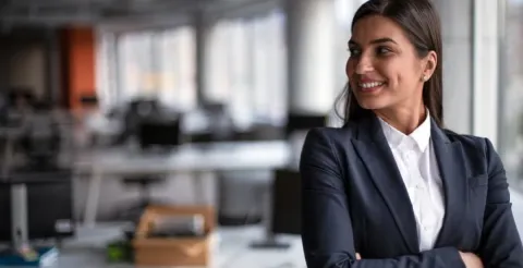 A smiling CFO with her arms crossed