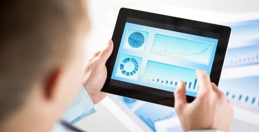 A data scientist reviews a visual dashboard on a tablet.
