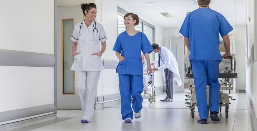 Medical professional walking in a hospital hallway.