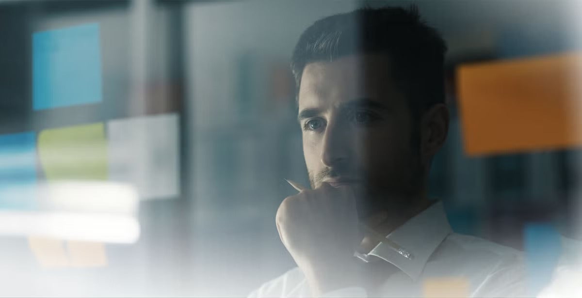 Man staring and pondering at a screen